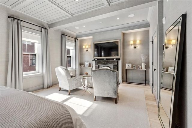 a living room with furniture a flat screen tv and a large window