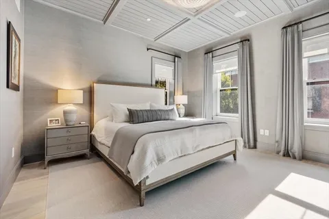 a bed room with a bed and a large window