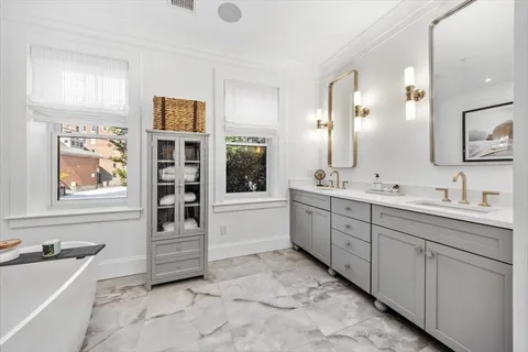 a spacious bathroom with a granite countertop sink mirror and bathtub