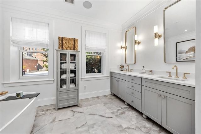 a spacious bathroom with a granite countertop sink mirror and bathtub