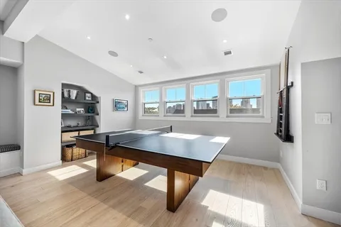 a room with stainless steel appliances kitchen island granite countertop a refrigerator and a stove