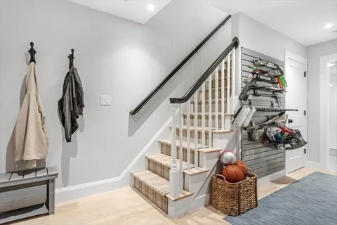 a view of entryway and hall with wooden floor