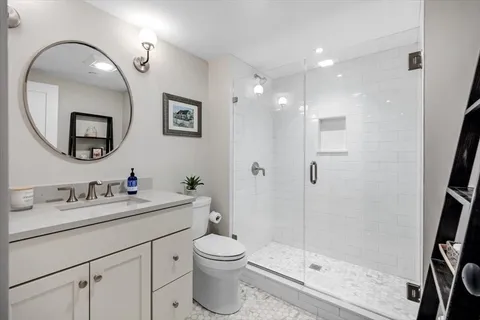 a bathroom with a toilet sink and mirror