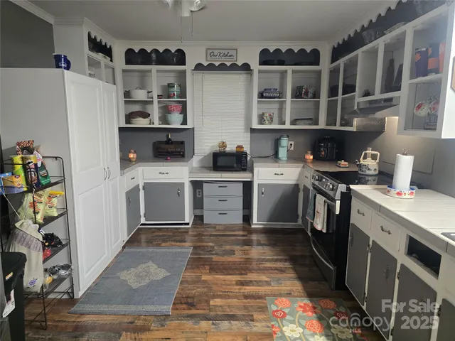 a view of a room with wooden floor and window