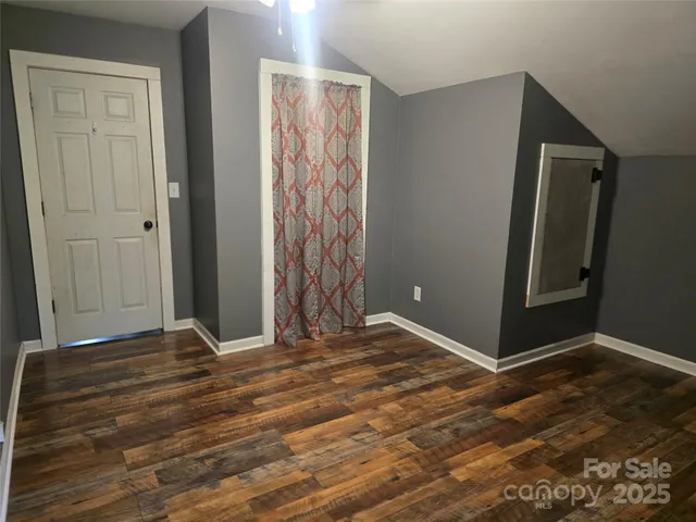 a bathroom with a granite countertop toilet sink and mirror