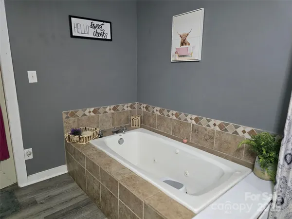 a bath tub sitting next to a white wall