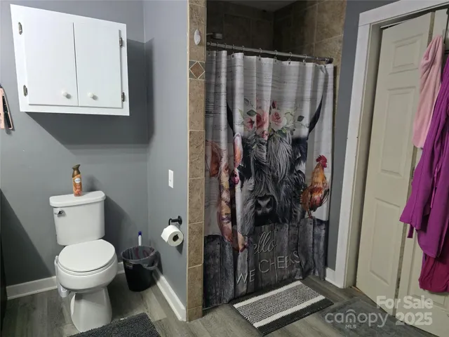 a room with a table chairs and a refrigerator