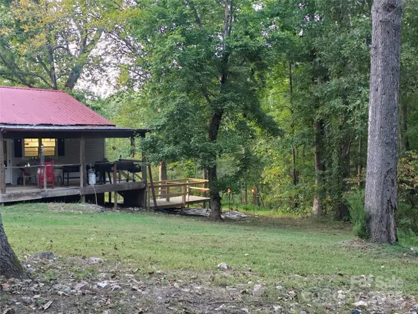 a backyard of a house with a table and chairs