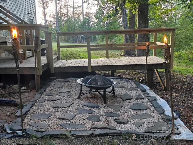 a view of a backyard with barn and a large tree