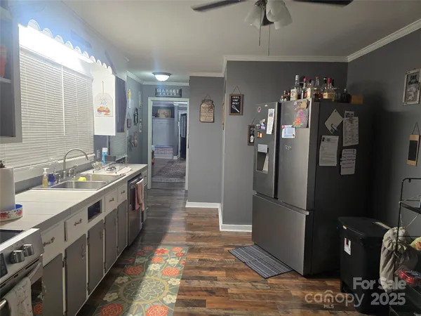 a large kitchen with a lot of counter space and stainless steel appliances