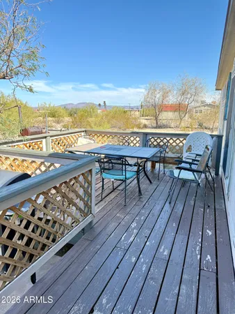 a view of roof deck with patio and wooden floor