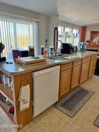 a kitchen with stainless steel appliances granite countertop a sink and a refrigerator