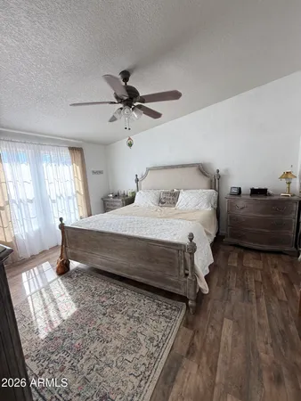 a bedroom with a bed dresser and a window