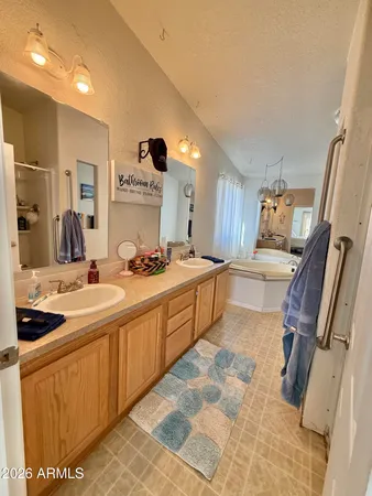 a large bathroom with a large mirror vanity and sink