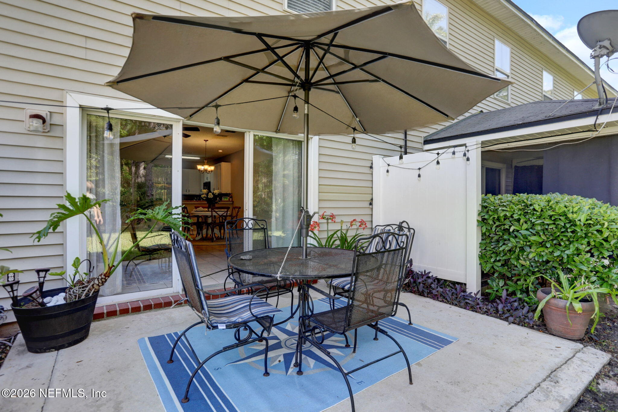 8629 Ribbon Falls Lane Jacksonville, FL 32244 - Photo 14 of 39 a view of a table and chairs under an umbrella