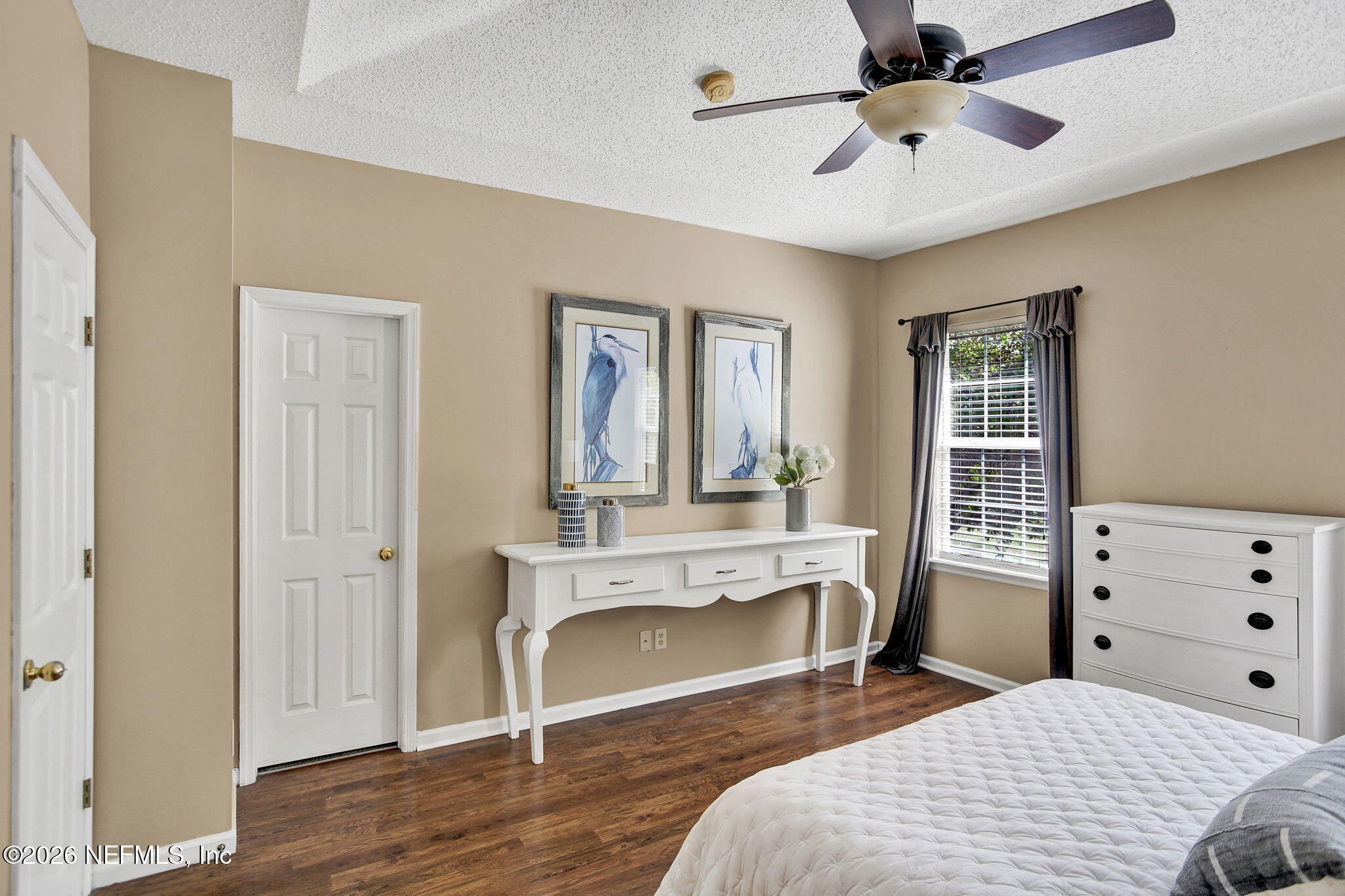 8629 Ribbon Falls Lane Jacksonville, FL 32244 - Photo 20 of 39 a bedroom with a bed a chandelier and a dresser