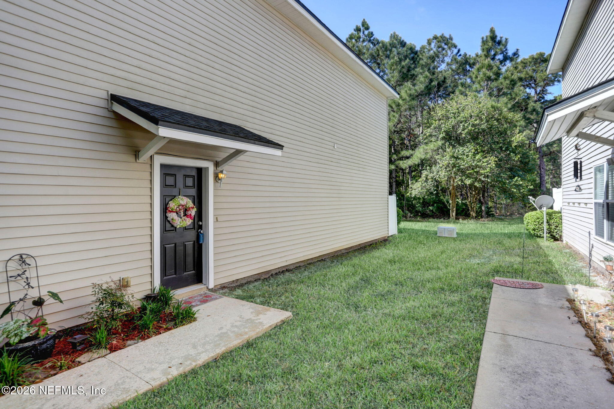 8629 Ribbon Falls Lane Jacksonville, FL 32244 - Photo 2 of 39 a front view of a house with garden