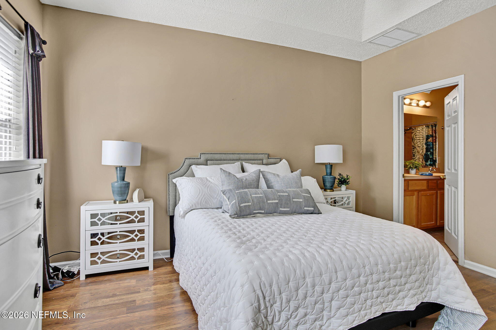 8629 Ribbon Falls Lane Jacksonville, FL 32244 - Photo 21 of 39 a bedroom with a bed and a night stand