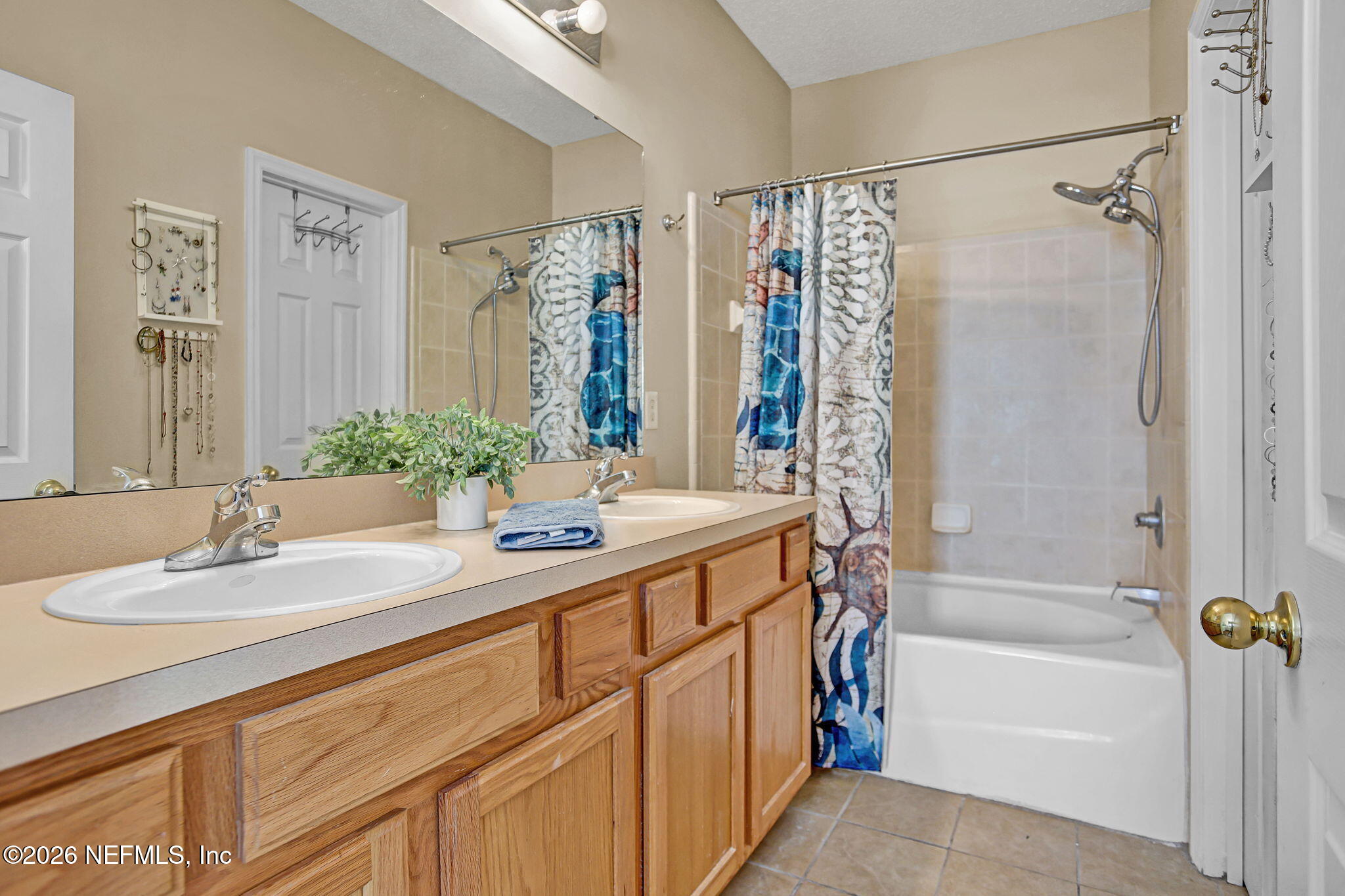 8629 Ribbon Falls Lane Jacksonville, FL 32244 - Photo 22 of 39 a bathroom with a granite countertop sink a mirror a shower and a bathtub