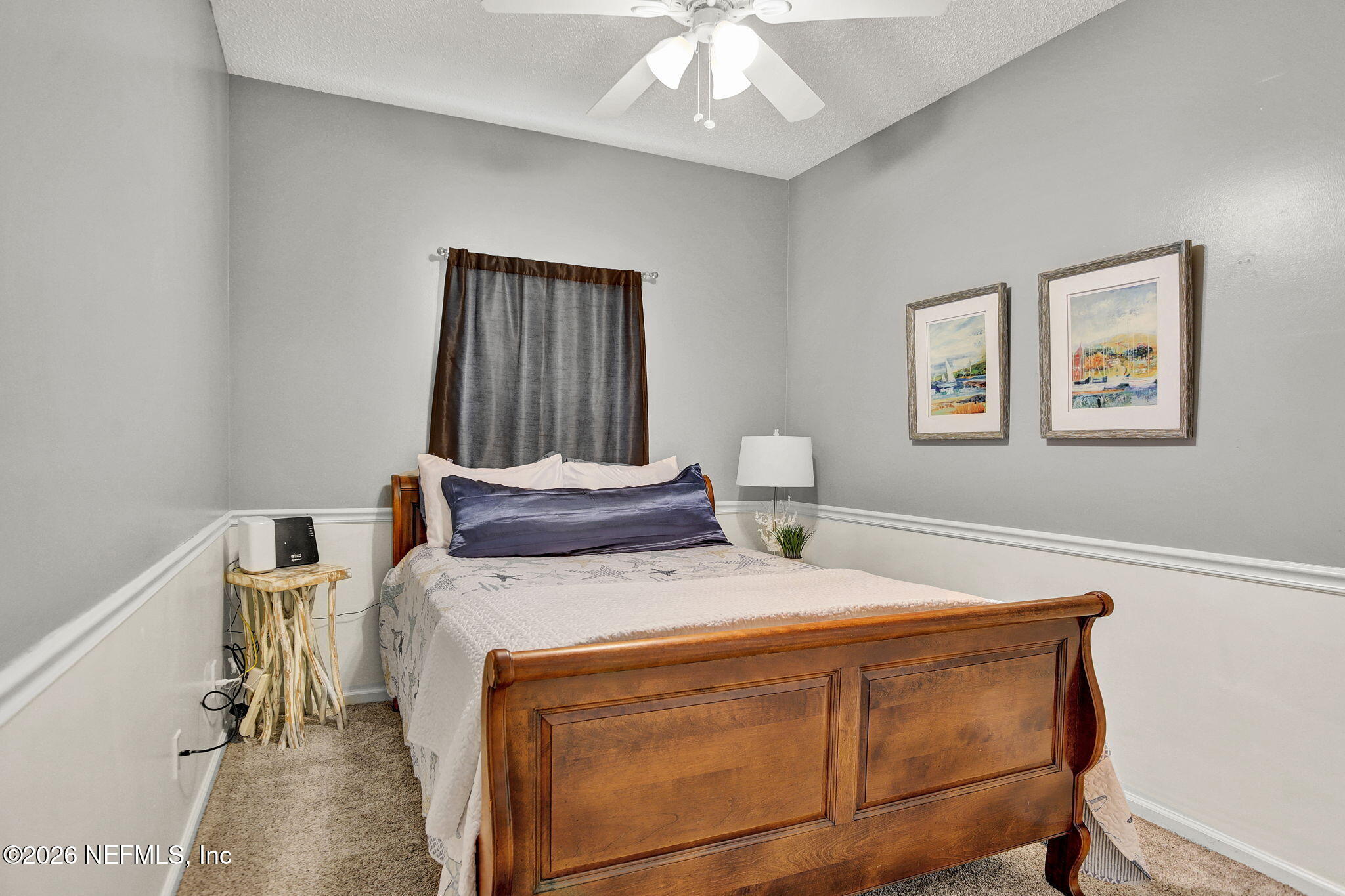 8629 Ribbon Falls Lane Jacksonville, FL 32244 - Photo 23 of 39 a bedroom with a bed and a chandelier