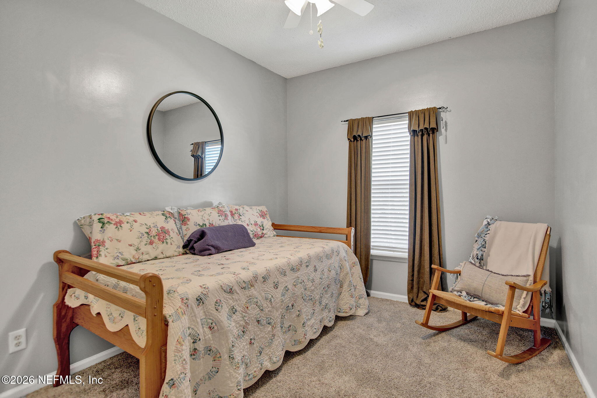 8629 Ribbon Falls Lane Jacksonville, FL 32244 - Photo 24 of 39 a bedroom with bed and a chair