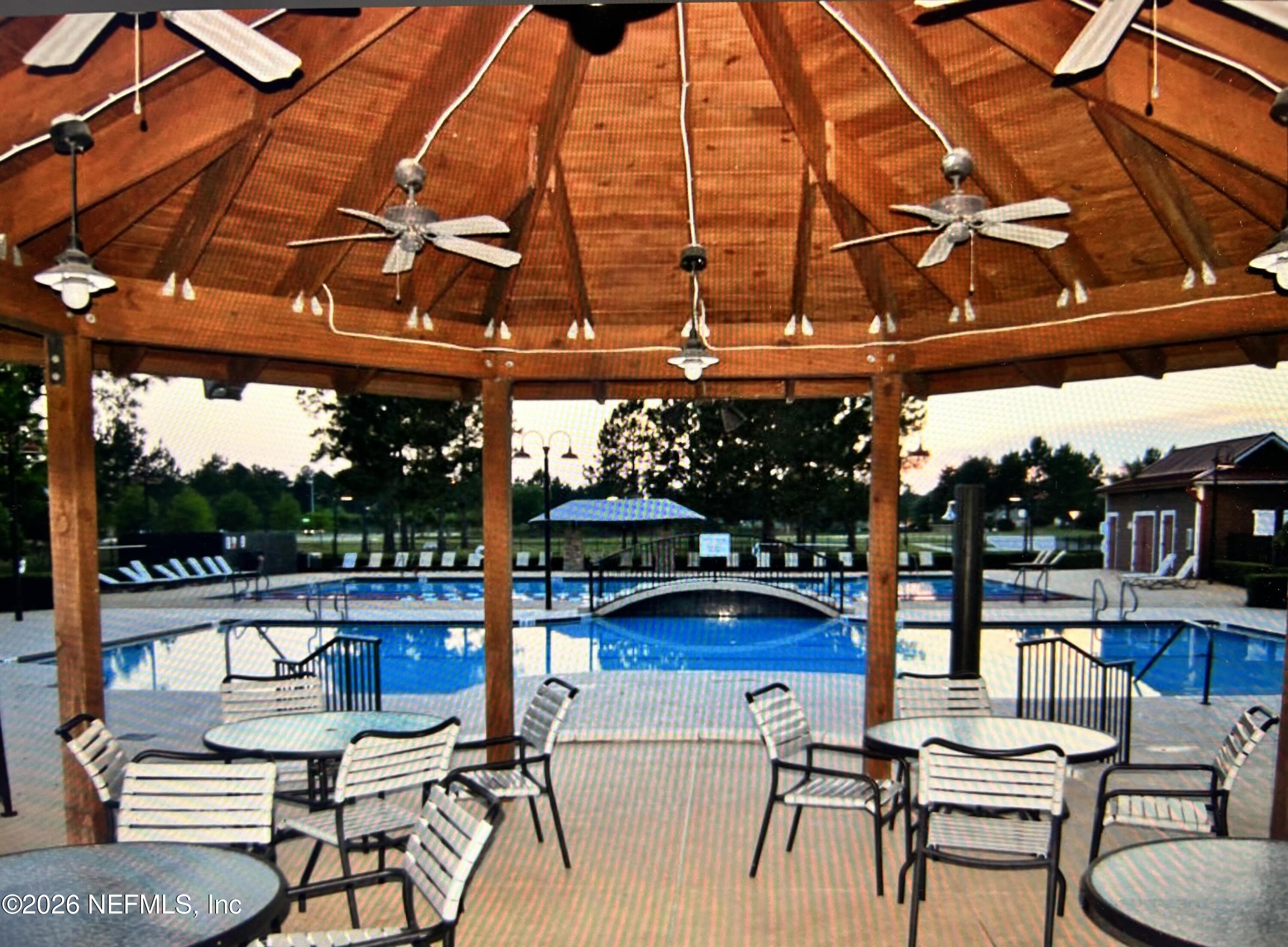 8629 Ribbon Falls Lane Jacksonville, FL 32244 - Photo 29 of 39 a view of a chairs and tables in patio