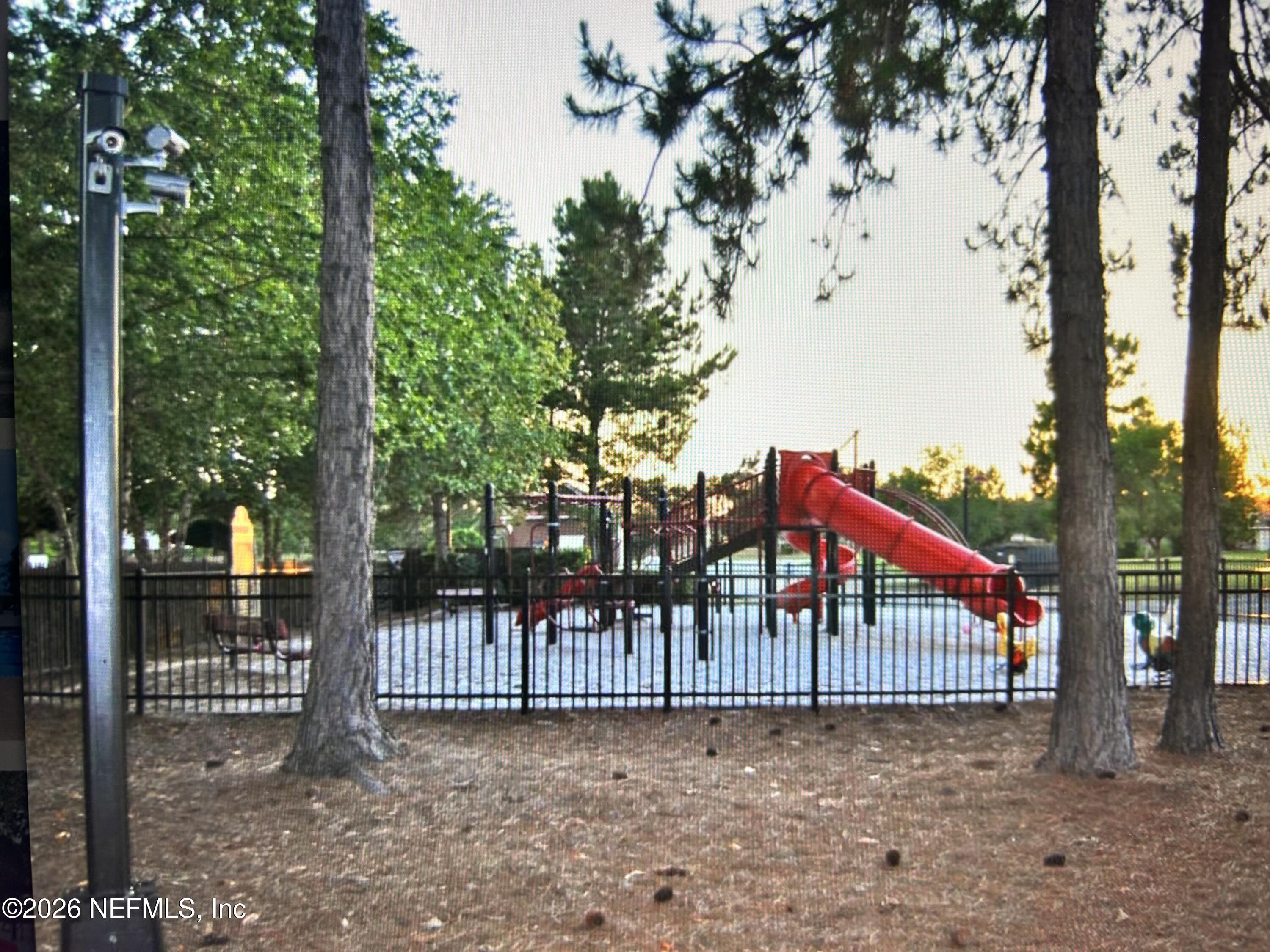 8629 Ribbon Falls Lane Jacksonville, FL 32244 - Photo 31 of 39 a view of a small yard in front of a house with wooden fence