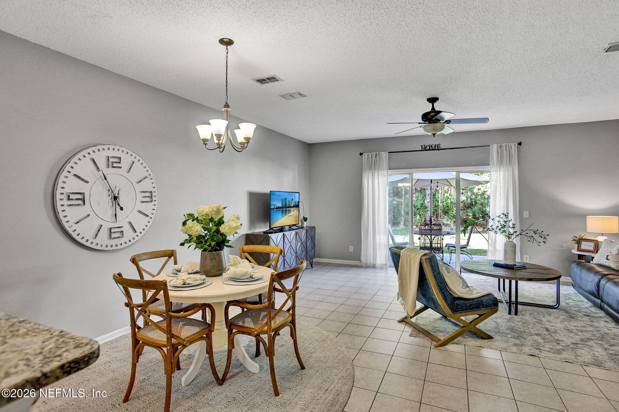 8629 Ribbon Falls Lane Jacksonville, FL 32244 - Photo 5 of 39 a view of a dining room and kitchen with furniture window and wooden floor