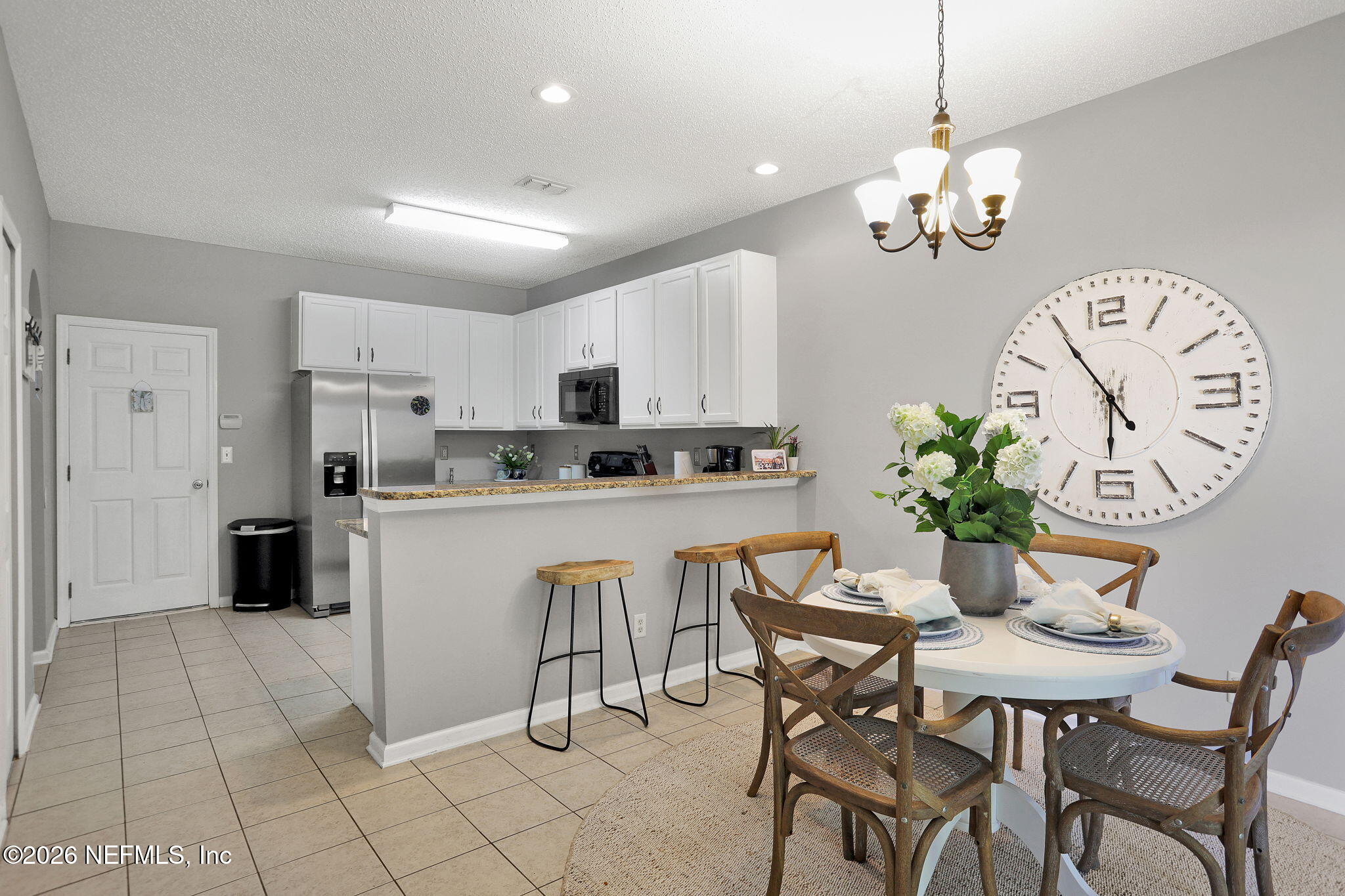 8629 Ribbon Falls Lane Jacksonville, FL 32244 - Photo 6 of 39 a dining room filled chandelier and kitchen view