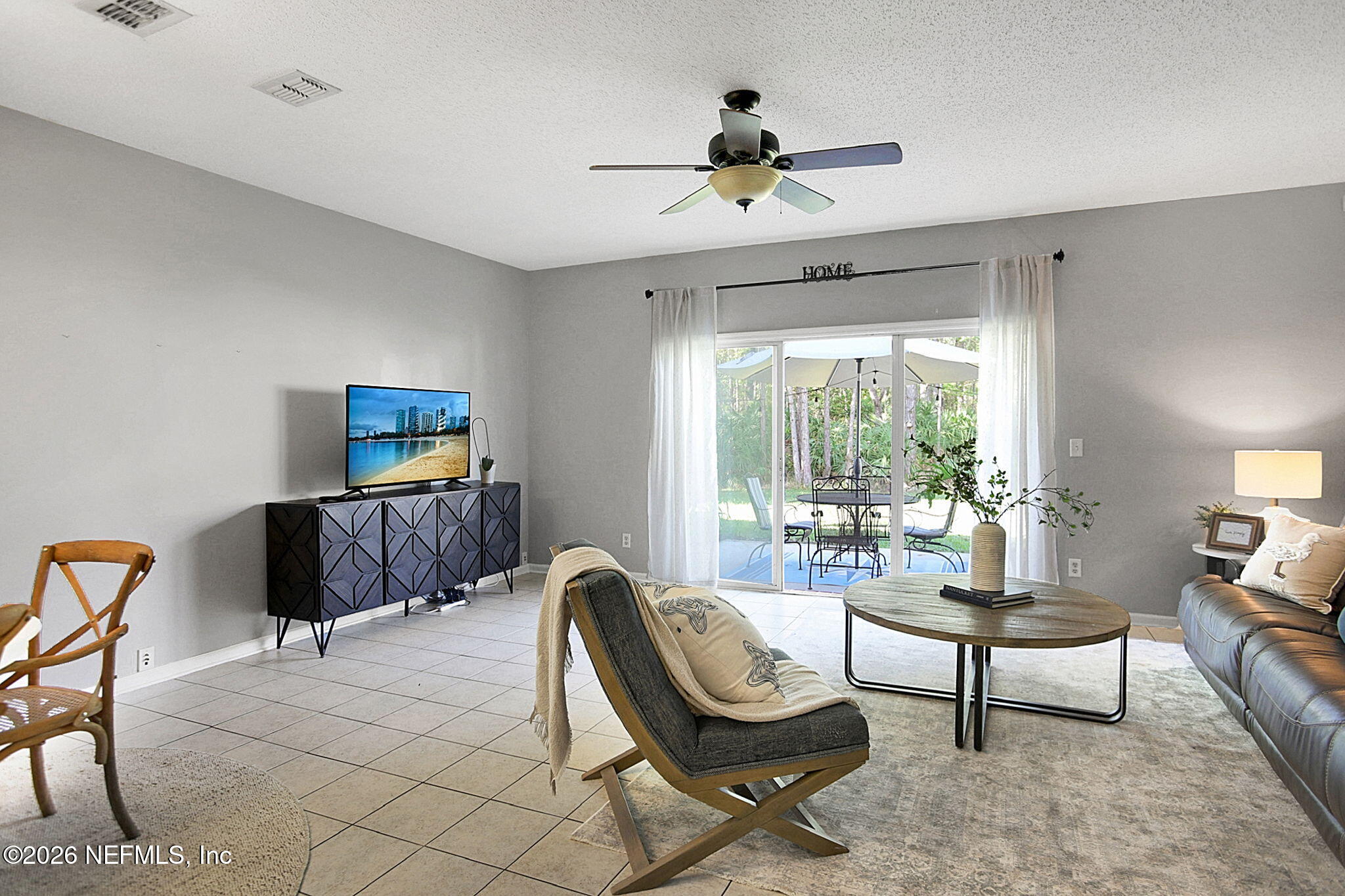8629 Ribbon Falls Lane Jacksonville, FL 32244 - Photo 9 of 39 a living room with furniture and a large window