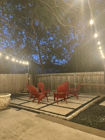1811 Old Mill Road Cedar Park, TX 78613 - Photo 39 of 39 An inviting backyard patio features string lights and a cozy seating area, perfect for evening gatherings. Schedule a showing today!