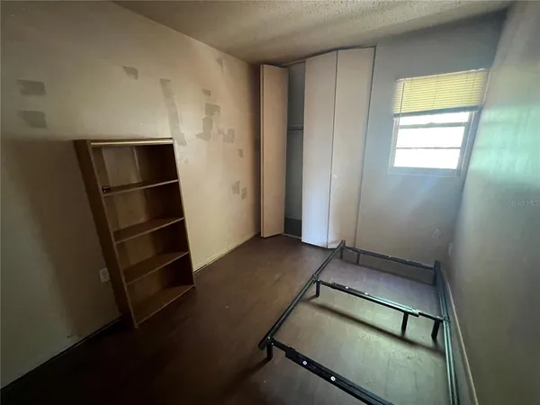 a view of a room with wooden floor and a window