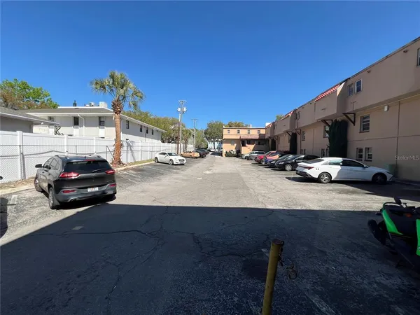a cars parked in front of a white building