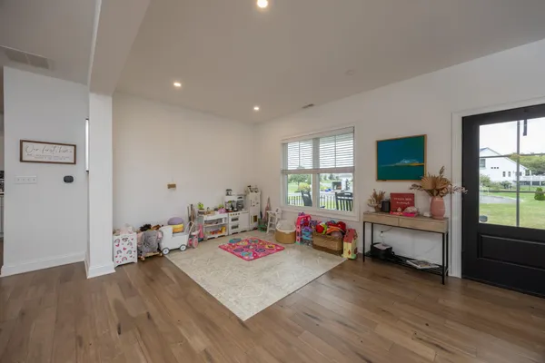 a bedroom with a bed dresser and a window