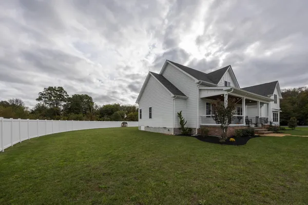 a large kitchen with stainless steel appliances kitchen island a large counter top and a stove top oven