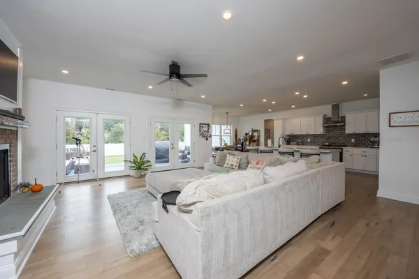 a kitchen with a table chairs stove and white cabinets