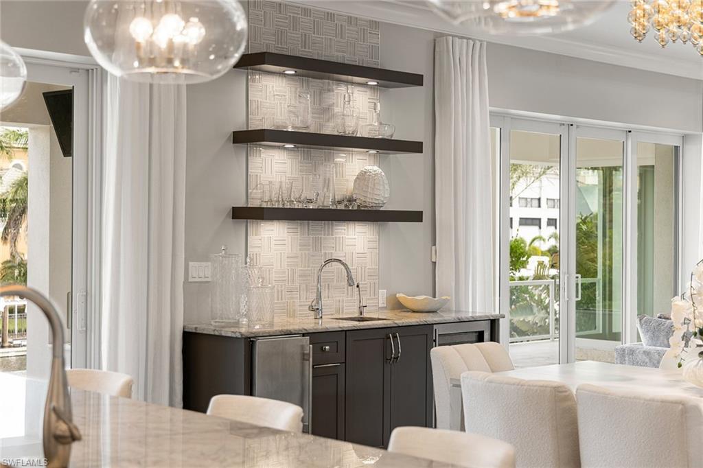 175 Conners Avenue Naples, FL 34108 - Photo 11 of 49 a kitchen with a sink and a refrigerator