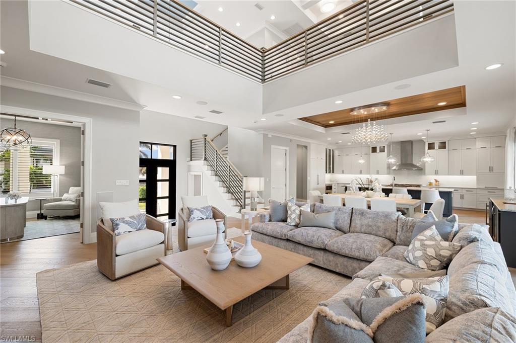 175 Conners Avenue Naples, FL 34108 - Photo 13 of 49 a living room with furniture and wooden floor