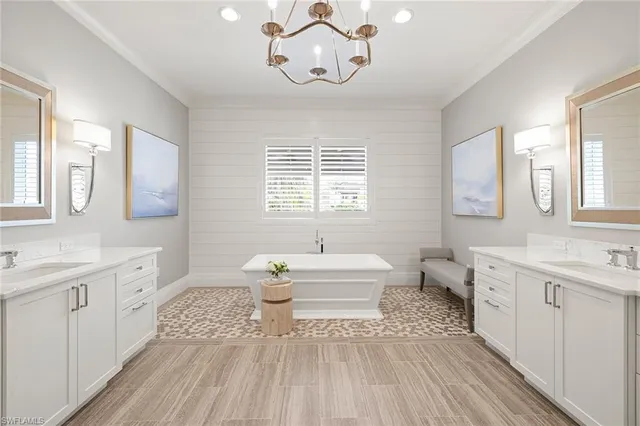 a spacious bathroom with a double vanity sink a large mirror and a toilet