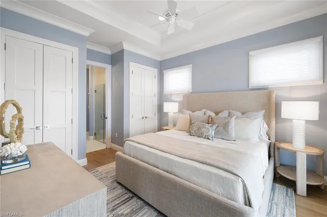 a bedroom with a large bed and a chandelier