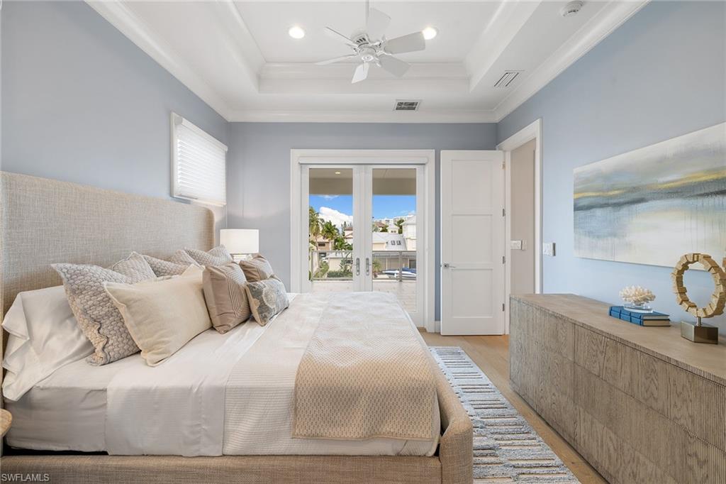 175 Conners Avenue Naples, FL 34108 - Photo 26 of 49 a bedroom with a bed and a large window