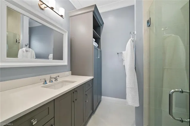 a bathroom with a double vanity sink and mirror