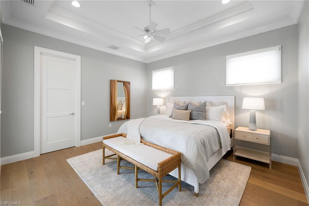 175 Conners Avenue Naples, FL 34108 - Photo 28 of 49 a bedroom with a bed and a table