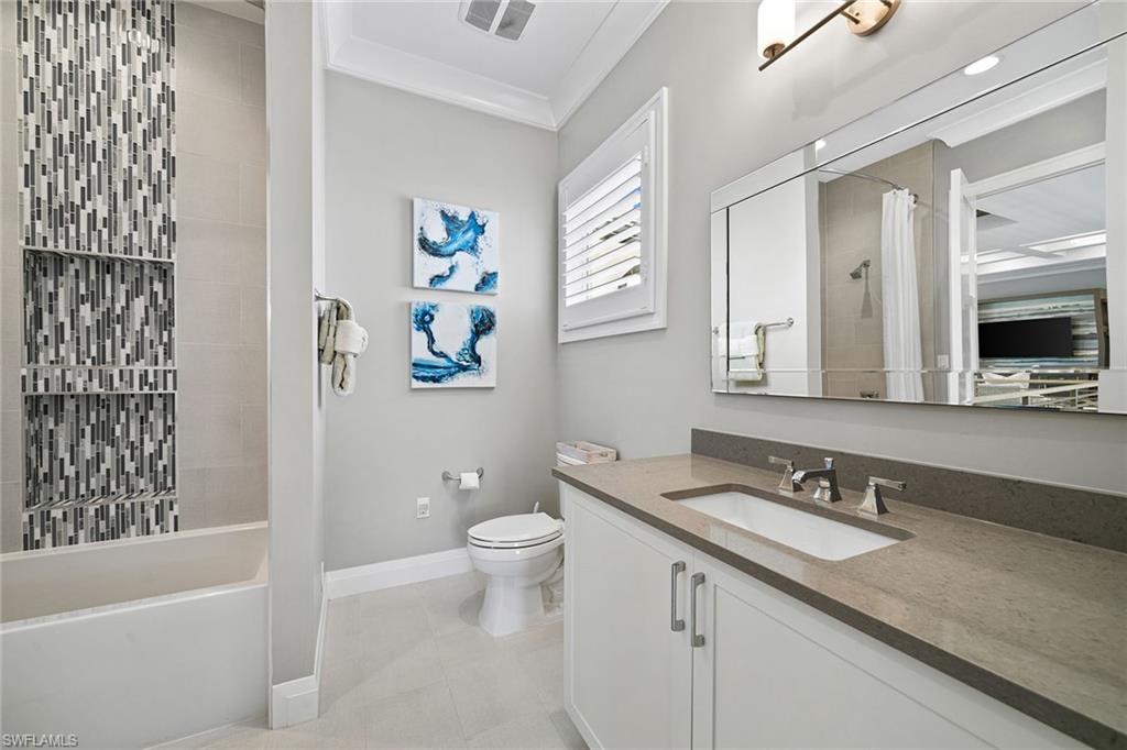 175 Conners Avenue Naples, FL 34108 - Photo 30 of 49 a bathroom with a granite countertop sink toilet and shower