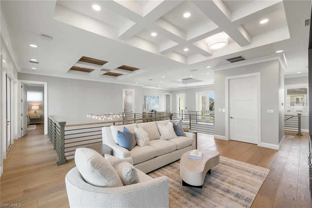 175 Conners Avenue Naples, FL 34108 - Photo 37 of 49 a living room with furniture and wooden floor