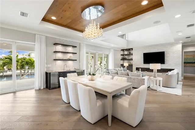 a large white kitchen with a large window and stainless steel appliances