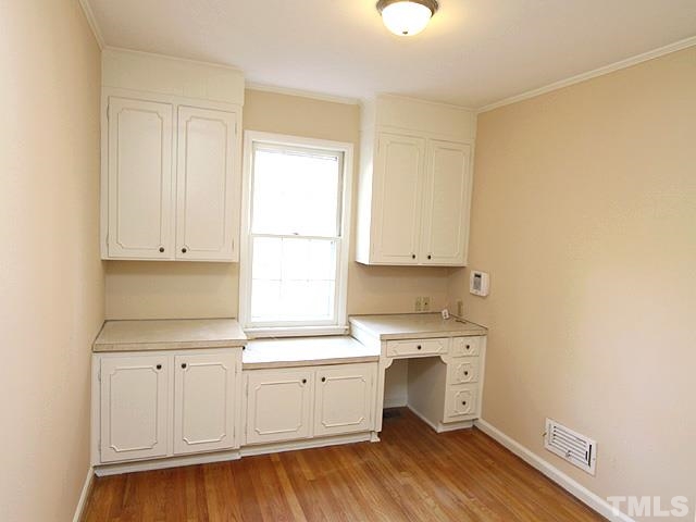 4500 Connell Drive Raleigh, NC 27612 - Photo 12 of 25 a view of a kitchen with wooden floor and a window
