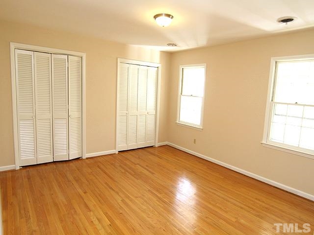 4500 Connell Drive Raleigh, NC 27612 - Photo 15 of 25 an empty room with wooden floor and windows