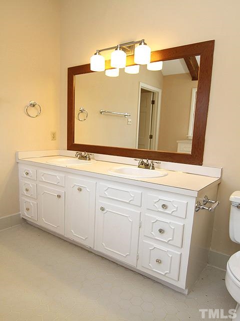 4500 Connell Drive Raleigh, NC 27612 - Photo 18 of 25 a bathroom with a sink a vanity and mirror