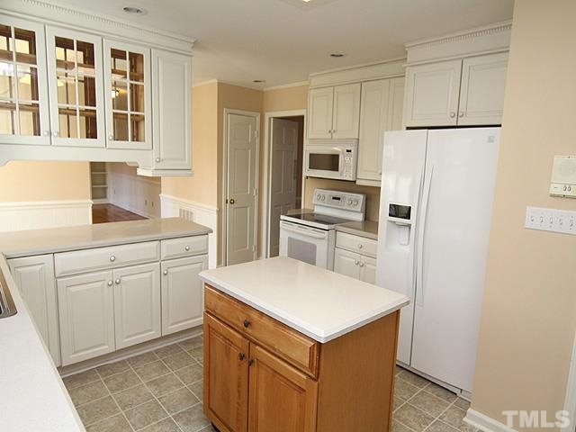 4500 Connell Drive Raleigh, NC 27612 - Photo 9 of 25 a kitchen with a refrigerator sink and cabinets